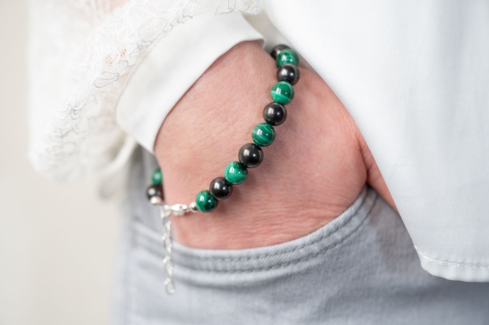 Shungite bracelet with extension chain for adjustable sizing. Elegant jewelry piece with a modern and refined appearance.
